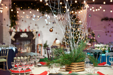Festive decoration of the table in honor of Christmas and New Year with Christmas trees 