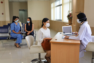 Patient wear face mask was sick and meet or talking with doctor or nurse in hospital, healthcare treatment process and covid-19 pandemic concept