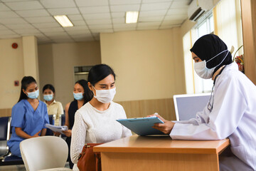 Patient wear face mask was sick and meet or talking with doctor or nurse in hospital, healthcare treatment process and covid-19 pandemic concept