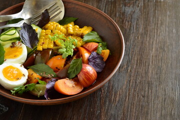 Corn salad with vegetables and boiled egg, copy space
