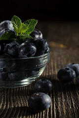 A vase of blueberries on the table close up.