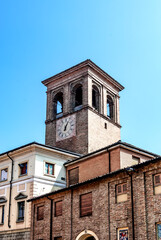 Fototapeta na wymiar The bell tower with clock of the College of San Francesco, house of the Museum of Natural Science of the Barnabites, beside the Church of Saint Francis, in Lodi, Lombardy, northern Italy.