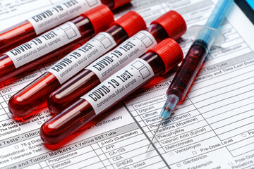 Clipboard with paper blank form with blood test tubes on blue background