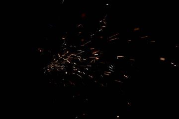 Glowing Flow of Sparks in the Dark. Fire sparks on a dark background
