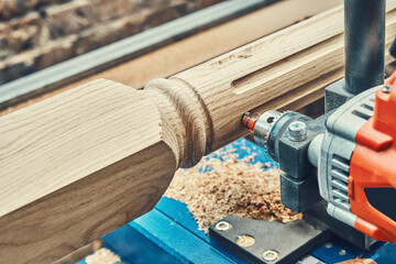 Turning wooden stair balusters. Wood stair balusters manufacturing process on a turning lathe with...