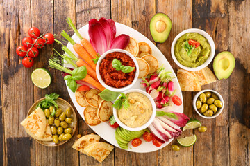 vegetable and dipping sauce on wood background
