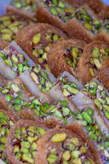 Arabic dessert or Sweets called in Arabic MABROUME is Kanafeh ( thin noodle-like pastry ) around pistachio and sugar-based syrup 