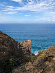 building ruin (Casa del Agua) at coast with ocean background, Tenerife