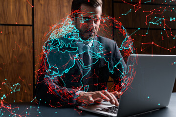 Businessman in office working with laptop, world map planet earth hologram, typing computer. Double exposure.