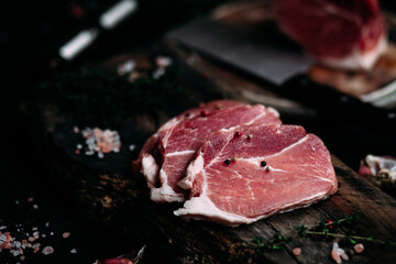 Raw pork steak on a wooden table