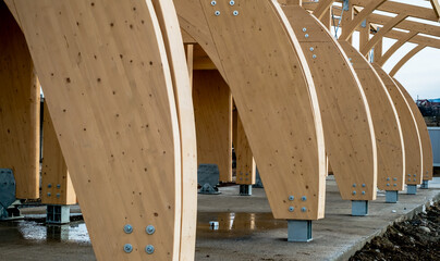 Detail of a modern wooden architecture in glued laminated timber on a blue cloudy sky