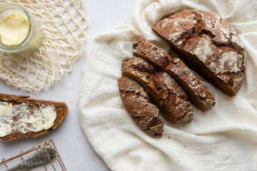 Rye round bread with butter. Rustic breakfast.