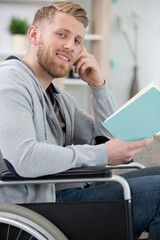 disabled man on wheelchair reading book