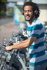 young attractive student is renting bike