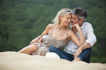 senior couple enjoying beach holiday on dune