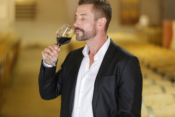 a sommelier tasting red wine