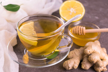 Tea with ginger honey and lemon in a transparent cup Healthy foods for treating colds