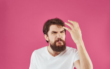 Man in white t-shirt tinplate hands emotions pink background