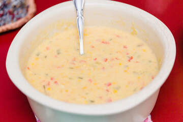 preparing the ingredients for a corn casserole for a family dinner