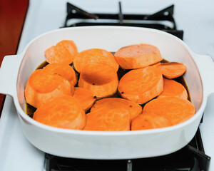 sweet potatoes being readied to become candied sweet potatoes for a holiday dinner