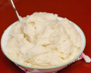 a bowl of mashed potatoes ready for a family dinner