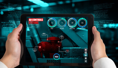 Engineer use augmented reality software in smart factory production line with automated application . Futuristic machinery in working in concept of Industry 4.0 or 4th industrial revolution.