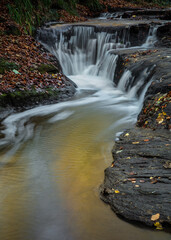 Golden Hole Waterfall in Holywell Dene in the county of Northumberland, England, UK. At the end of autumn.