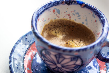 a cosy winterly snowflake cup of strong espresso