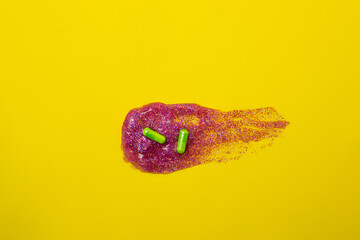 Green pills flying, on a yellow background.