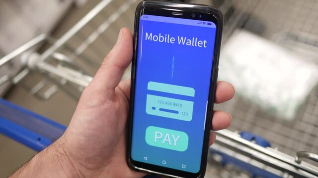 Waiting in line at a store with a mobile wallet on a smartphone screen ready to pay for the purchase.