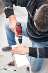 Handyman worker assembling furniture and fixing it.
