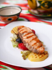 Salmon steak on a pillow of stewed vegetables. Asian style