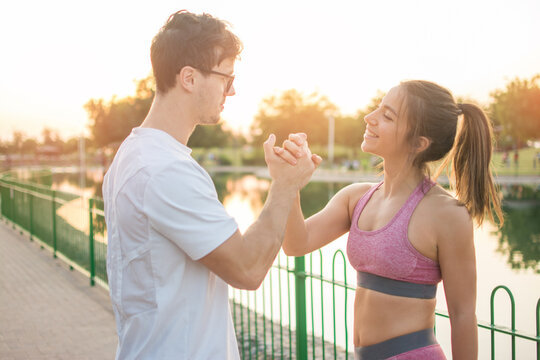 Motivated couple of runners celebrating their new record. Sporty people training outdoors.