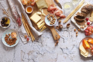 Appetizers table with various of cheese, curred meat, sausage, olives, nuts and fruits. Festive...