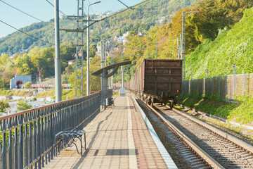 Freight train moves along the platform by Black sea coast.
