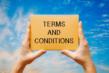 Man holding a card with text Terms and Conditions,