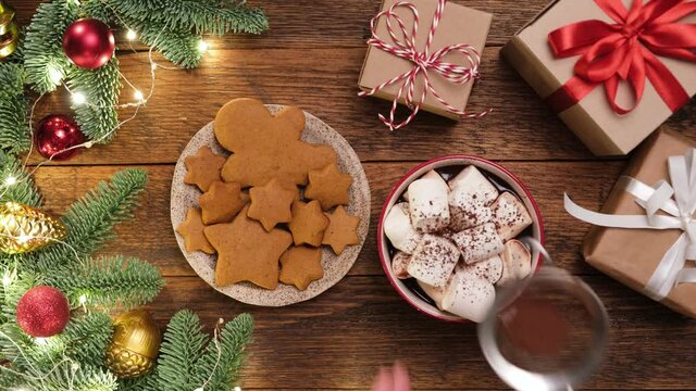 Hot chocolate with marshmallows, gingerbread cookies on wooden table. Christmas, New Year concept background. Winter holidays