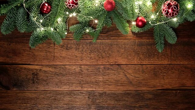Christmas background with wooden planks and christmas fir tree, lights and decorations. Copy space for design elements, text or movie