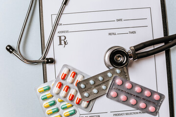 Medical concept flat lay with stethoscope, pills, medical prescription on the doctor desktop