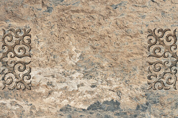 Ornamental print on the stone surface. Vintage ornament on the stone. Embossed drawing. Close-up....