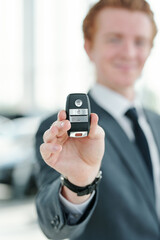 Hand of young manager or seller of vehicles holding remote control alarm system