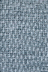 Close-up of woven surface. Light blue tinted fabric background. Top view from above. Pale faded braided backdrop for sewing or handicraft. Vertical wallpaper