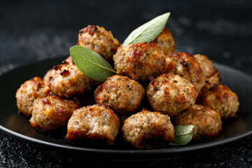 Pork stuffing meatballs with sage and onion in a black plate
