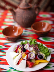  Vegetable slicing in Georgian style - tomatoes, cucumbers, greens, Bulgarian pepper, cheese, onion. Asian style