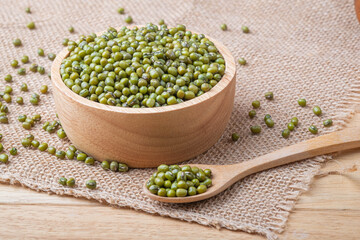 Green beans seed or Green nuts seeds in wooden spoon and a bowl on on a wooden table, Close-up and macro shot, Organic food from nature concept.