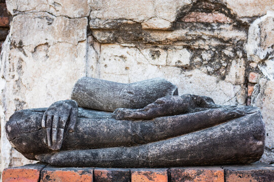 Half body of a Buddha statue in seated position, right hand resting on knee and fingers pointing towards the earth, left hand palm facing upwards. Temple Wat Maha That, Ayutthaya, Thailand, Asia