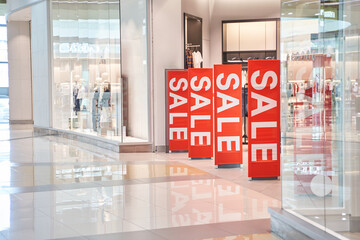 Sale red sign at mall. Discount concept. Market interior design. Selling business model. Lifestyle promotion. Store promo graphic. Shop background. Cheap boutique. Retail commercial price. Money offer