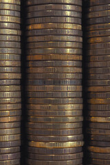 Background or wall from piles and edges of yellow brass coins close-up. 10 ten Russian rubles. Dark textured backdrop or wallpaper for economic, banking, financial, monetary topics. Macro