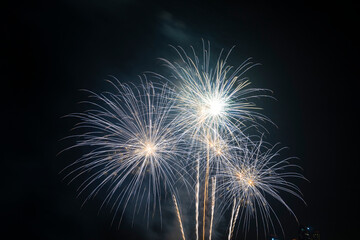 Firework festival with beach foreground and city background at Pattaya beach, Thailand. Colorful firework in celebration festival background