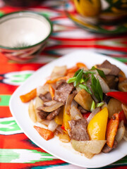  Fried beef meat in oil with potatoes, onions, bell peppers according to the Uyghur recipe